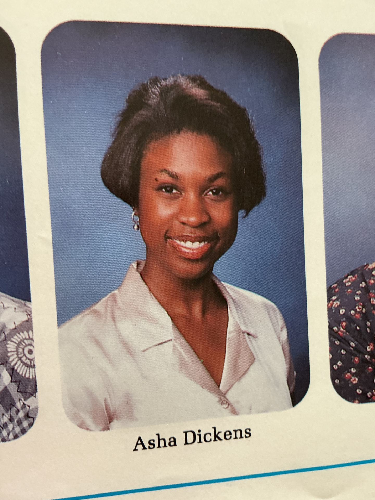 A 1996 Kenwood Academy senior portrait of Asha Dickens against a blue studio backdrop.