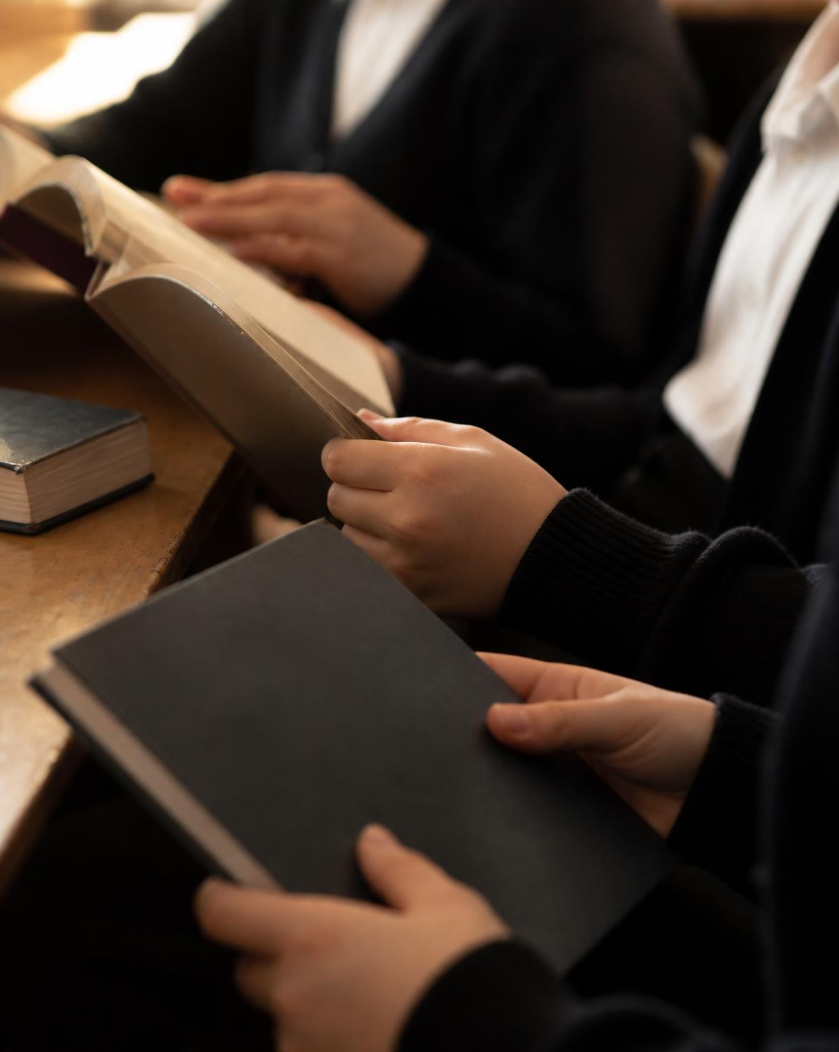 Students reading together at a library table.